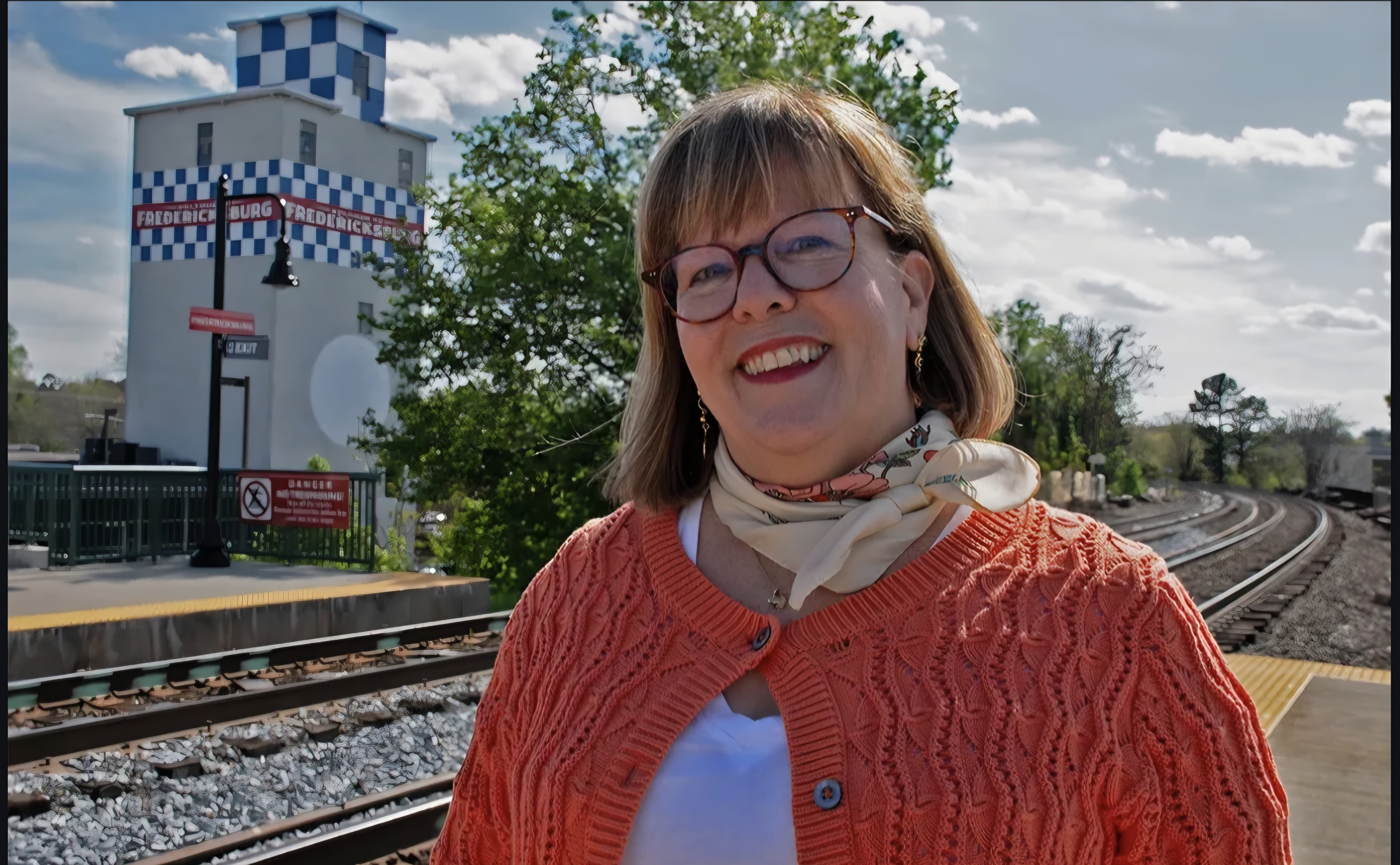 Jannan Holmes at the Fredericksburg train station with the Purina Tower behind her